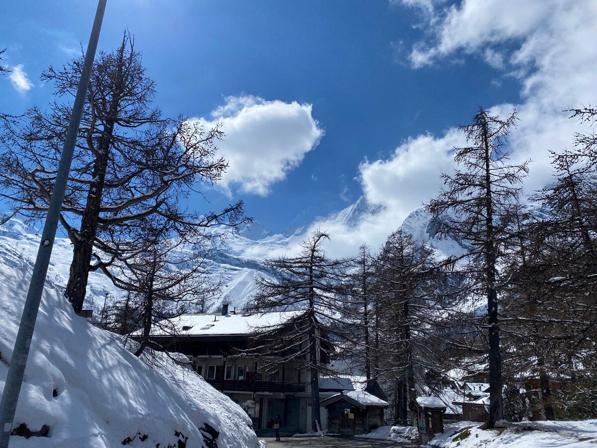 Winter scene with mountains and chalet