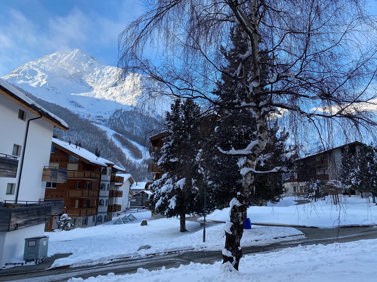 Winter village with blue sky and peaks