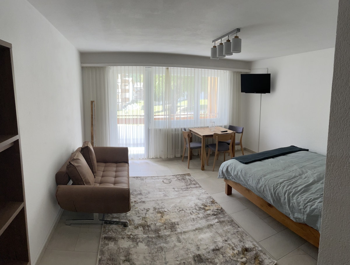 Studio overview with balcony curtains